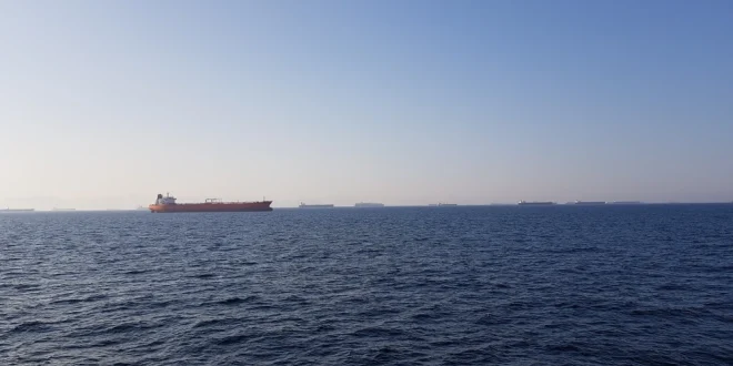 Cargo ships line the horizon in the Strait of Hormuz.Shutterstock