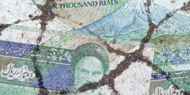 The image of an Iranian rial on cracked asphalt.Shutterstock